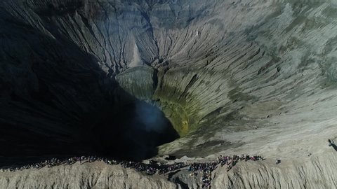 Aerial view of volcano crater Mount Gunung Bromo. An active volcano,Tengger Semeru National Park. Reveal shot crater with active volcano smoke in East Java, Wonderful Indonesia.