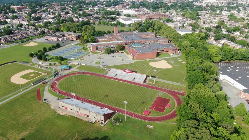 High aerial of school college university campus athletic fields, grounds and school buildings in Lancaster Pennsylvania USA Royalty-Free Stock Footage #1057426000