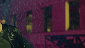 Footage of a crowd or group of young, stylish multi-ethnic people dancing in the rain . Colorful outdoor party at raining day . Dancers having fun dancing at party . Shot on ARRI ALEXA in Slow Motion