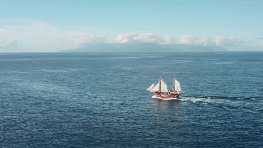 Pirate wooden sailing ship is sailing full speed in the open ocean Royalty-Free Stock Footage #1057446478