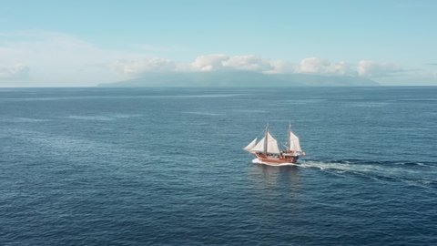 Pirate wooden sailing ship is sailing full speed in the open ocean