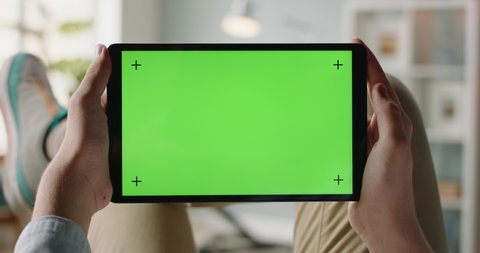 Close up shot of man using a laptop computer, watching a video. Green screen mock up chroma key template 4k footage