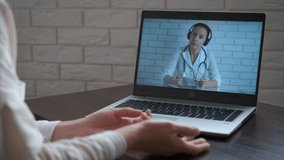 Virtual doctor consultation. A woman has a virtual consultation with a doctor about her health problem. A concept of modern treatment and telemedicine.
