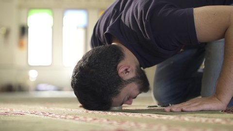A young Muslim prayer praying inside a mosque
