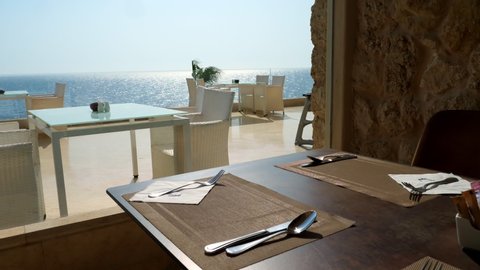 served table in the restaurant by a large panoramic window overlooking the sea.