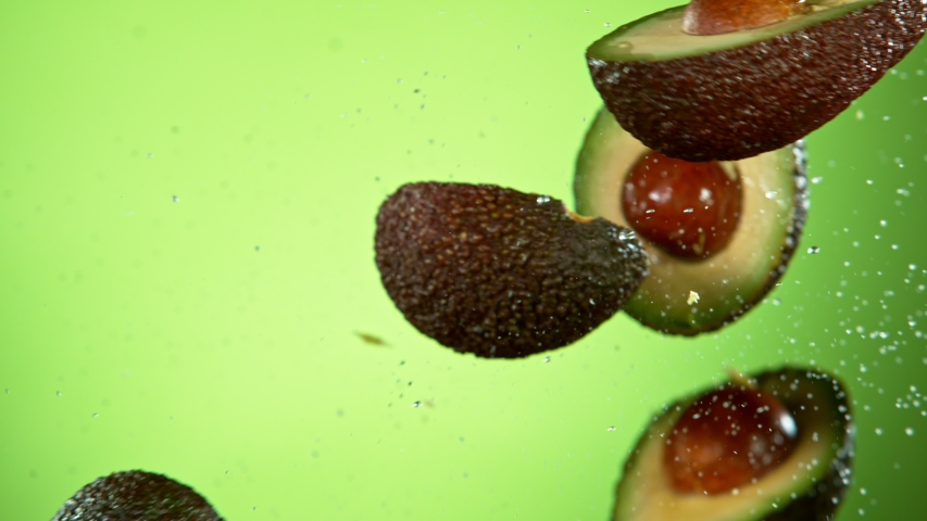 Super Slow Motion Shot of Flying Avocado, Collision in the Air at 1000fps. Royalty-Free Stock Footage #1057466872