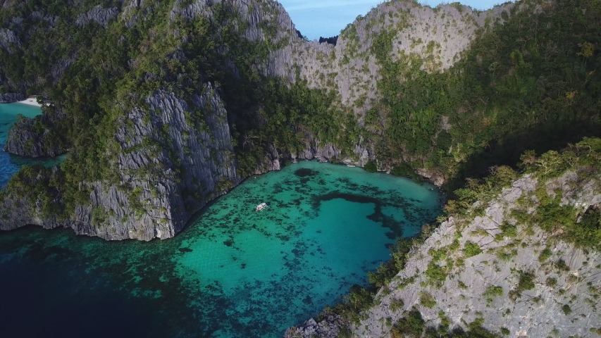 Philippines, Coron Island, Ocean Cliffs and Coral Reef Lagoon, AERIAL REVEAL