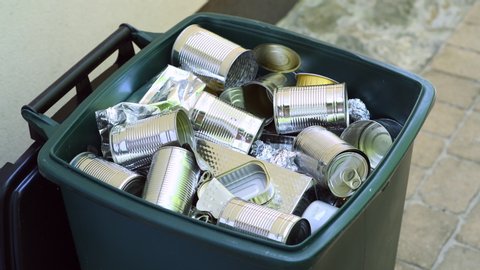 Wastebin full of metal tins and cans ready for recycling	