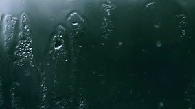 Rainy weather. Water drops streaming on window glass. Sadness concept. 4k video. Dull colors