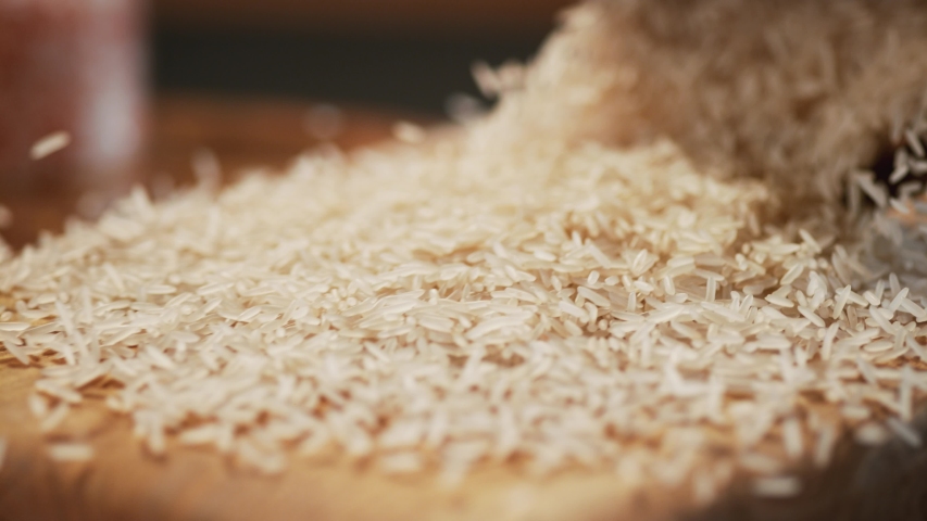 Basmati rice on a delicious background and wood floor passes in front of the camera in slow motion. Macro, 4K, Phantom Camera,Very Close-up, 900 fps video. | Shutterstock HD Video #1057484902