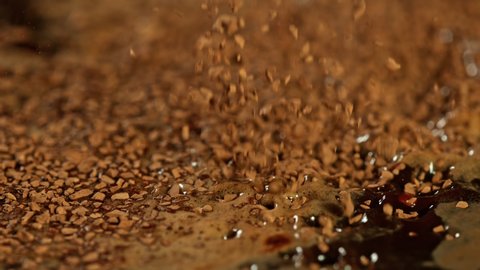 Super Slow Motion Macro Shot of Instant Coffee Falling into Water at 1000fps.