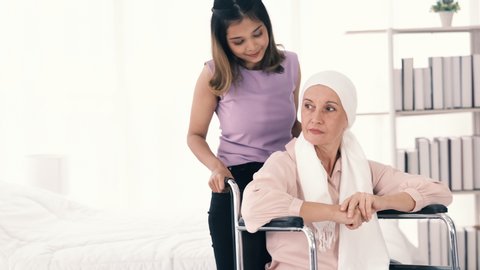A young girl takes care of  cancer patient. She spends vacation time at nursing home to look after a cancer patient. concept cancer patient need best care.