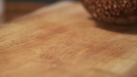 Buckwheat grains on a delicious background and wood floor passes in front of the camera in slow motion. Macro, 4K, Phantom Camera,Very Close-up, 900 fps video.