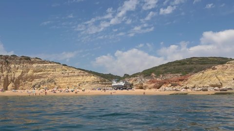 Lagoa, Portugal - July 11, 2020: View from the sea of one of Carvoeiro beach. The Lagoa region has a coastline formed of towering cliffs, turquoise waters and picturesque beaches.