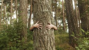 Arms Hugging a Tree In a Forest, showing Love and Care for Nature and Environment of Earth. - Powered by Shutterstock - Get 15% off with code: PIKWIZARD15