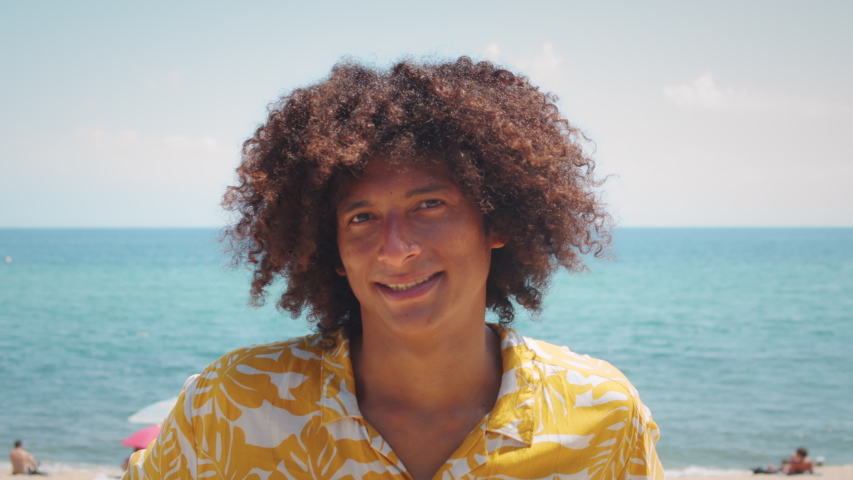 Portrait of a smiling african american young man, happy smiling latin male, Afro curly haircut. Stylish young brazilian student on street, dreadlocks dreads hair. | Shutterstock HD Video #1057515406