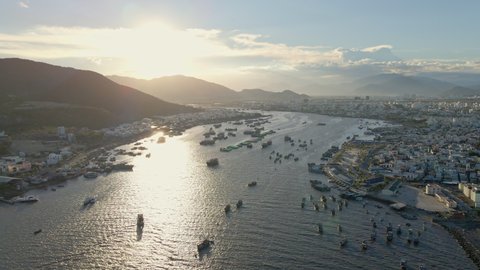 Aerial slow motion shot of touristic boats in a busy Nha Trang harbor. Travel to Vietnam concept.