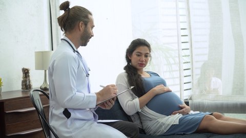 gynecologist doctor examining and consulting to pregnant woman in medical office at at hospital