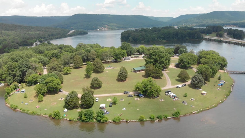 Aerial view of Tennessee lake with boats, trees, water, and other nature at a state park