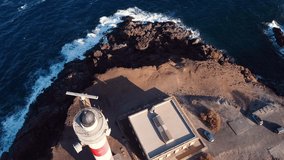 Scenic aerial view of a Lighthouse in volcanic coastline landscape. Tenerife, Canary Islands, Spain. Aerial 4K video. High quality 4k footage