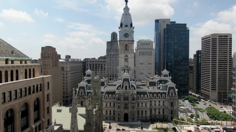 Aerial tilt up, Ben Franklin atop Philadelphia City Hall, view above Broad Street looking south