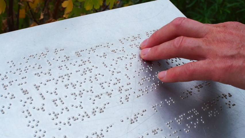 Hand touches the description in Braille. Typhlo pedagogue takes into account the blind and visually impaired people to read, instills in them self-service skills, the ability to navigate in space. | Shutterstock HD Video #1057528696