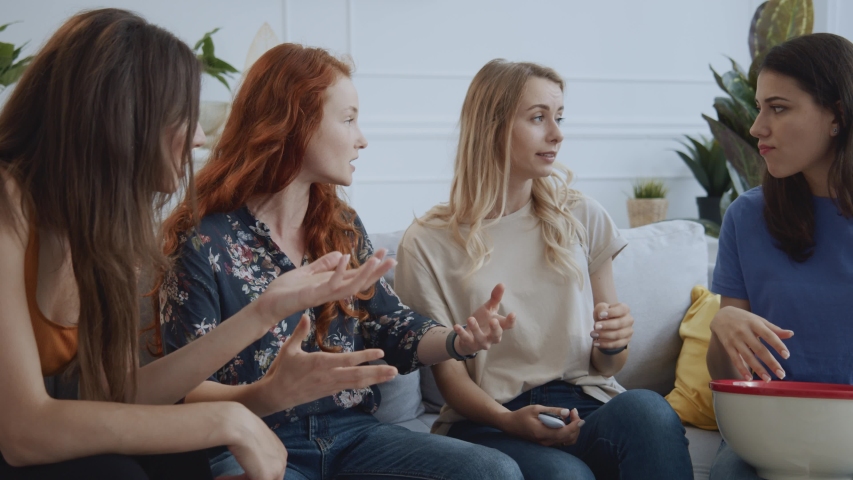Young woman losing the argument with friends turning on their favorite TV show leaning back in frustration. Conflict. Funny scene. | Shutterstock HD Video #1057532953