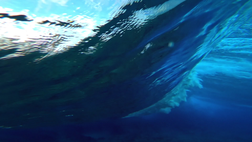 Ocean wave. Underwater view of the clear ocean wave breaking over the hard reef bottom in Maldives Royalty-Free Stock Footage #1057544227