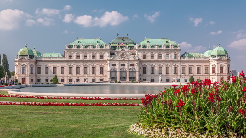 Belvedere palace with beautiful floral garden timelapse, Vienna Austria. Blue sky with clouds on sunny day. Green lawn and historic buildings
