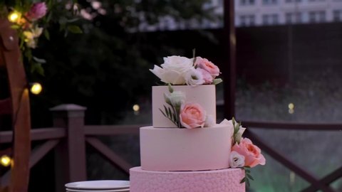 pink big cake. Three-tiered wedding cake.	