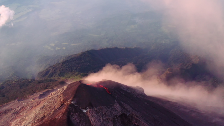 Complete, crazy flyover of the crater of Fuego, one of Guatemala's active volcanos. Shot ends with camera right above crater. More from this sequence available for sale. Royalty-Free Stock Footage #1057561570