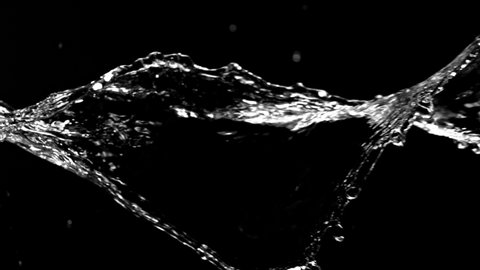 Super Slow Motion Shot of Swirling and Splashing Water Isolated on Black Background at 1000fps.