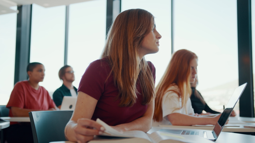 Female student sitting at her desk and paying attention to the lecture. High school classroom with students studying.
 | Shutterstock HD Video #1057573723