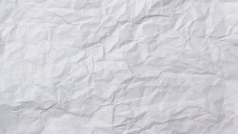 White crumpled wrinkled sheet of paper background texture. Stop motion animation. Seamless looping.