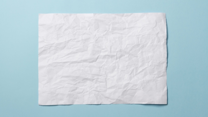 White crumpled paper texture on light blue background. Stop motion animation.  You can combine this clip with paper balls and icons to make a message or tale. | Shutterstock HD Video #1057573849