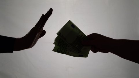 Silhouette of business man hands giving bribe isolated on gray background. Corruption, stop bribe concept. Refusing money
