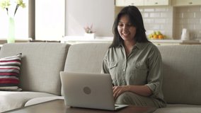 Smiling young indian woman video calling for remote job interview using laptop webcam conference work at home office. Happy lady talking by virtual chat meeting dating online using computer videocall.