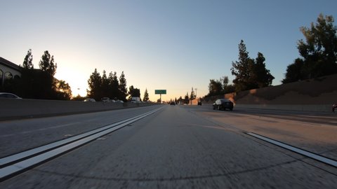 Azusa, California, USA - August 8, 2020:  Dawn driving car mount time lapse in on 210 Freeway in Los Angeles County, California.