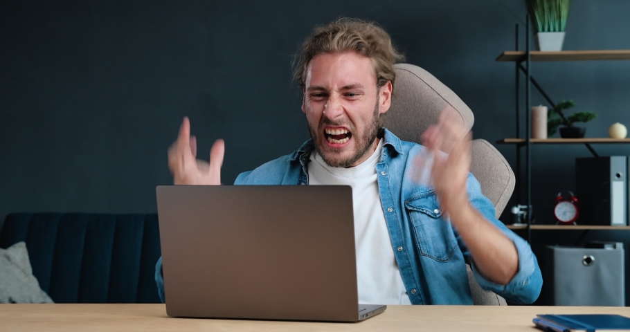 Stressed overworked Businessman feels frustrated by data loss, using Laptop at Home Office. Shocked male user looks at Computer screen reads bad news, has Unexpected online Website problem. Royalty-Free Stock Footage #1057584724
