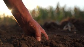 Close up of male hands touching dry ground in an agricultural field, Soil, cultivated dirt, earth, ground, Organic gardening, agriculture. Nature close up. Environmental texture, pattern. Mud on field - Powered by Shutterstock - Get 15% off with code: PIKWIZARD15