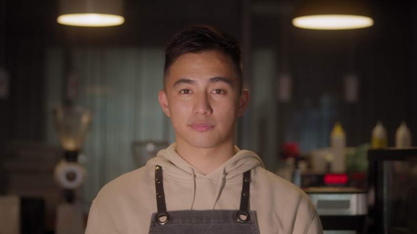 Asian young man remove protective mask at work, covid coronavirus , healthy lifestyle, business owner in new normal post covid, second wave, man barman smiling