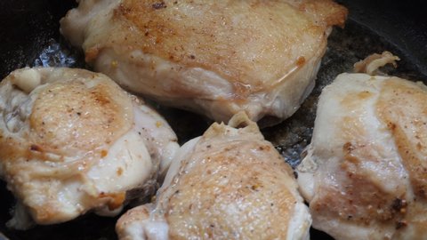Simple food, cooking. Chicken pieces are fried in a pan. Close-up.