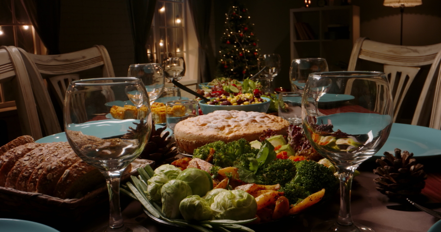 Close up shot of family celebration dinner table served with healthy vegetarian meals. holiday party table during thanksgiving or christmas - food and drink concept 4k footage