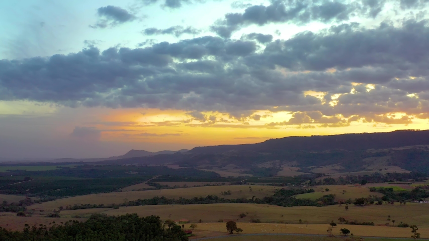 Sunset in rural area. Countryside scene. Aerial view of sunset in countryside. Rural landscape. Rural life. Rural Area. Sunset scene. Agriculture field. Sunset skyline. Aerial landscape of countryside