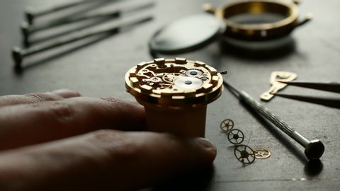 Watchmaker is repearing mechanical wrist watch