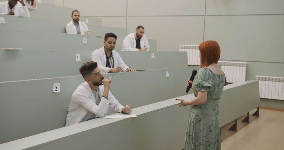 Afro-american medical student girl is late for a lecture at university and has a conversation with a teacher.