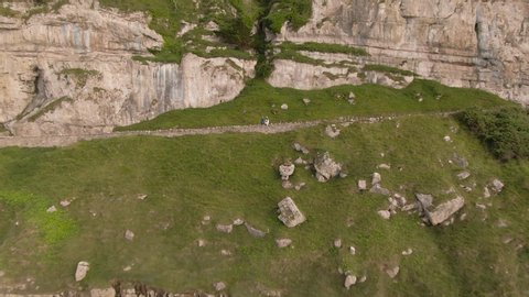 Aerial footage of scenic Great Orme, beautiful mountain cliff edge in coastal town Llandudno, North Wales near Snowdonia National Park. Mountain and Ocean View. Lush Landscapes.