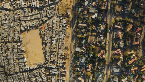 Inequality.Poverty.Aerial straight down view of an informal settlement Kya Sands squatter camp right next to middle class suburban housing, Gauteng Province, South Africa