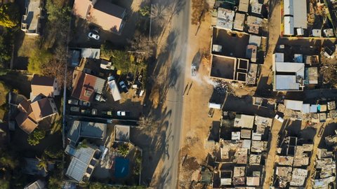 Poverty.Inequality.Aerial close-up straight down view of an informal settlement Kya Sands squatter camp right next to middle class suburban housing, Gauteng Province, South Africa