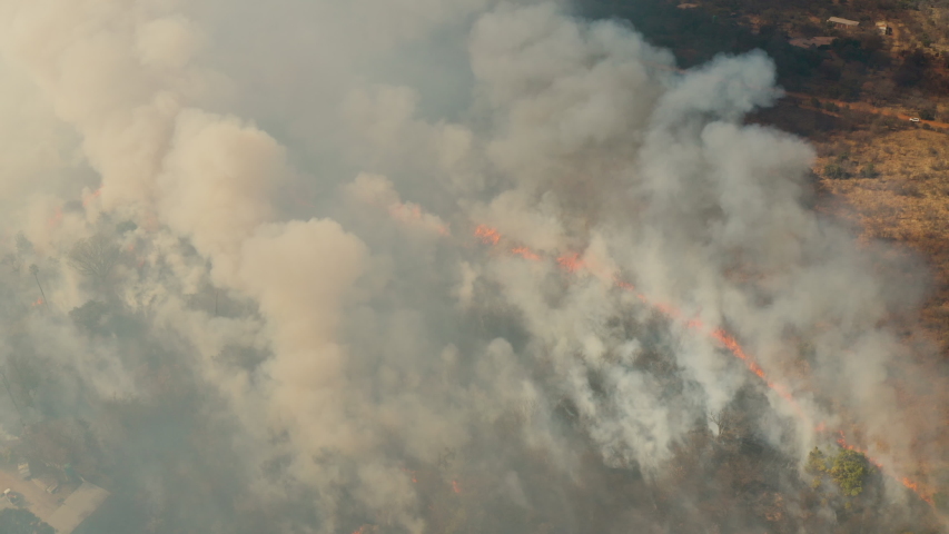 Climate emergency. Climate change. Global warming. Epic spectacular aerial close-up zoom in view of a grass fire in Southern Africa caused by drought and climate change Royalty-Free Stock Footage #1057611481